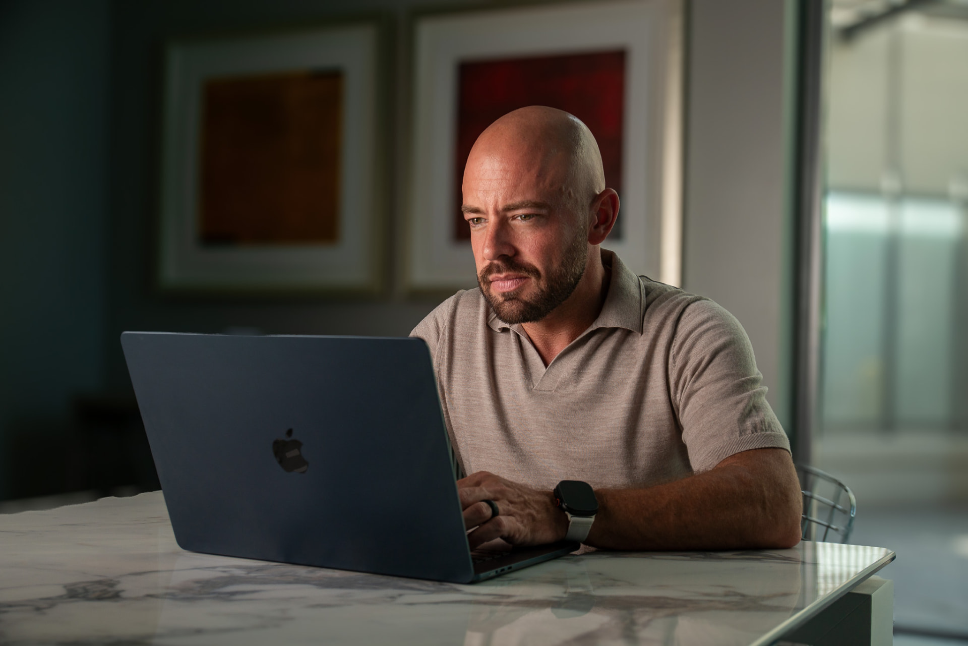 Ernie Beltz Jr. working at a desk on a laptop